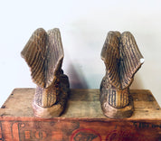 Pair of vintage ceramic eagle bookends with detailed wings perched on wooden base, gold-toned finish, suitable for library or bookshelf decor