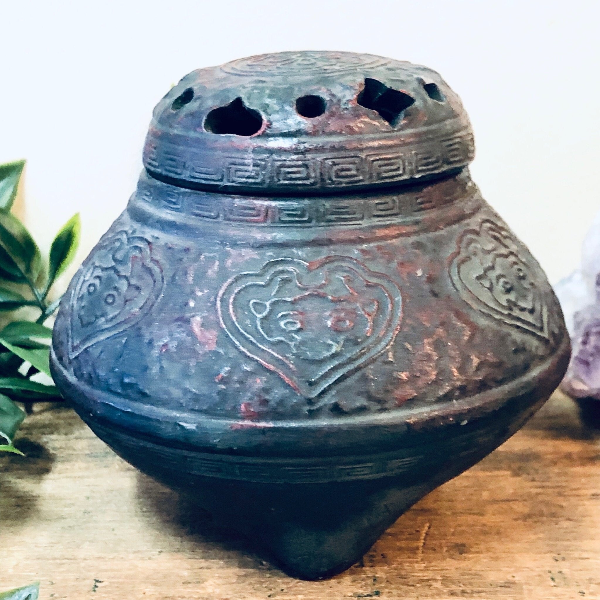 Vintage ceramic incense burner with intricate floral design and heart-shaped cutouts, in deep green and maroon glazed finish, perfect as a unique housewarming gift or home decor accent piece.