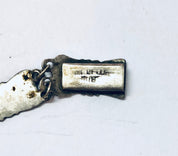 Vintage Siam sterling silver enamel bracelet charm with blue accents and ancient text engraving, photographed on a white background.
