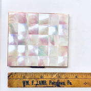 Vintage mother of pearl cigarette case or business card holder with pink and white checkerboard pattern, shown with a wooden ruler for scale.