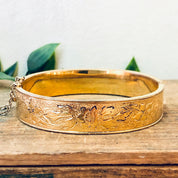Vintage gold filled bangle bracelet with intricate etched floral design