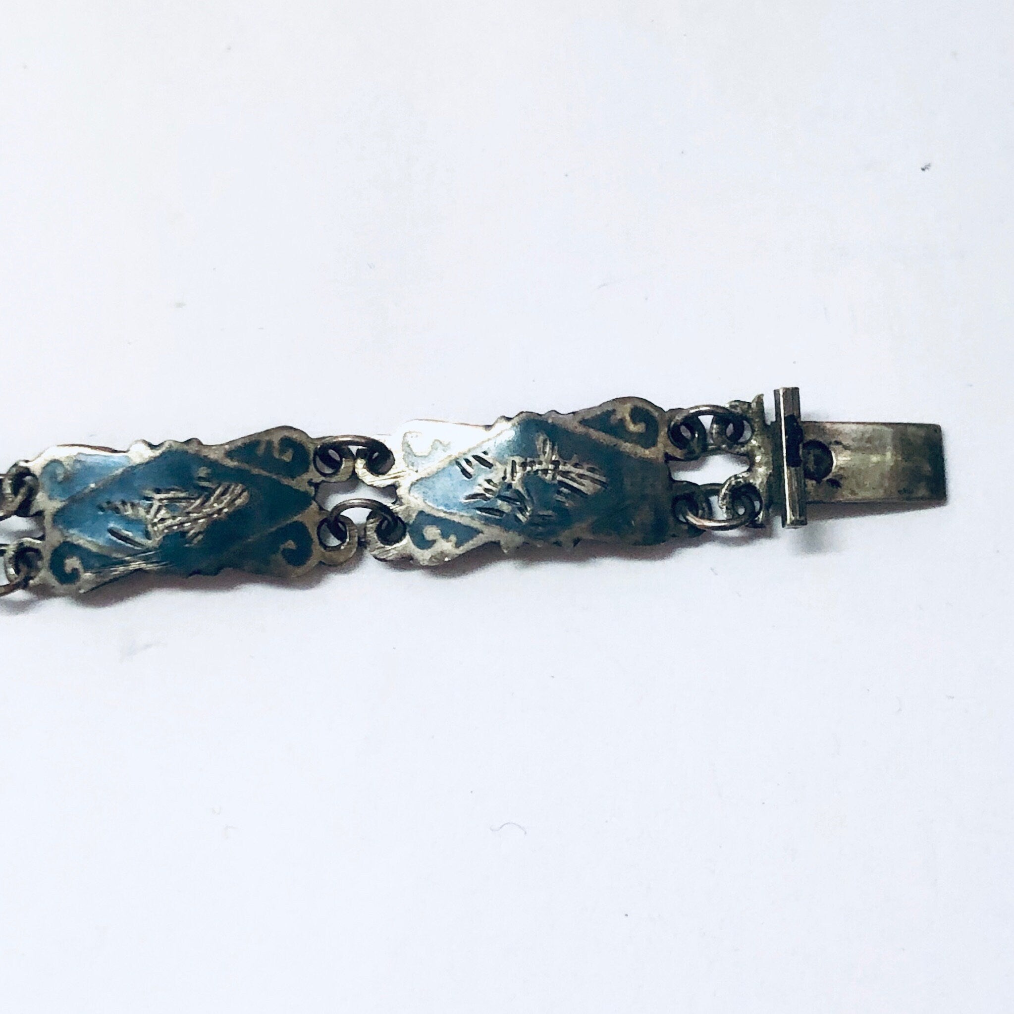 Vintage sterling silver bracelet with blue enamel featuring goddess motifs, a small bracelet marked Siam 925 silver.