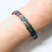 Vintage Siam sterling silver bracelet with blue enamel design, small size, on wrist