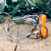 Vintage butterscotch amber leaf cuff bracelet in 925 silver on a natural background