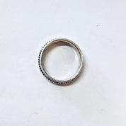 Vintage silver spinner meditation ring with unique ribbed texture on a plain white background