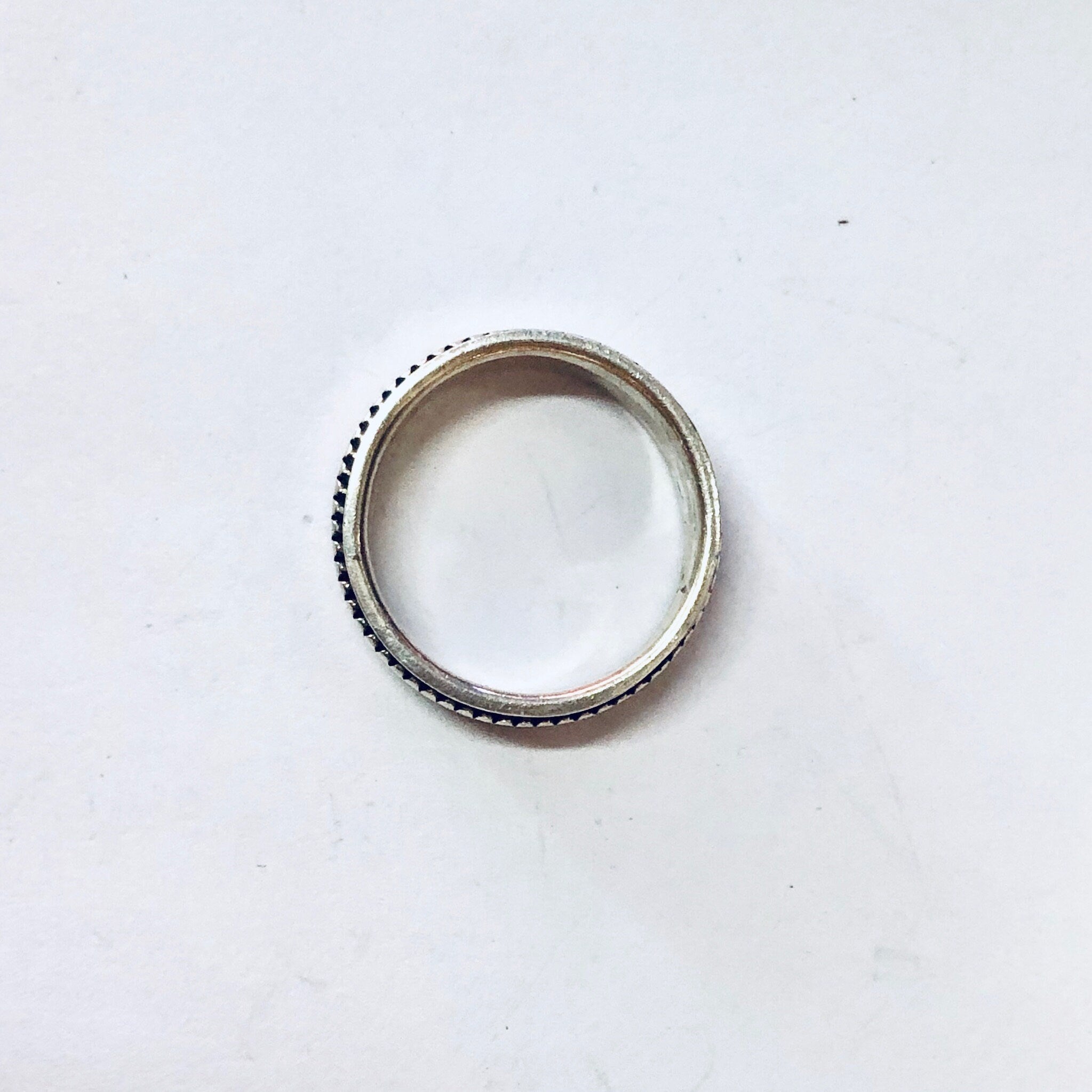 Vintage silver spinner meditation ring with unique ribbed texture on a plain white background