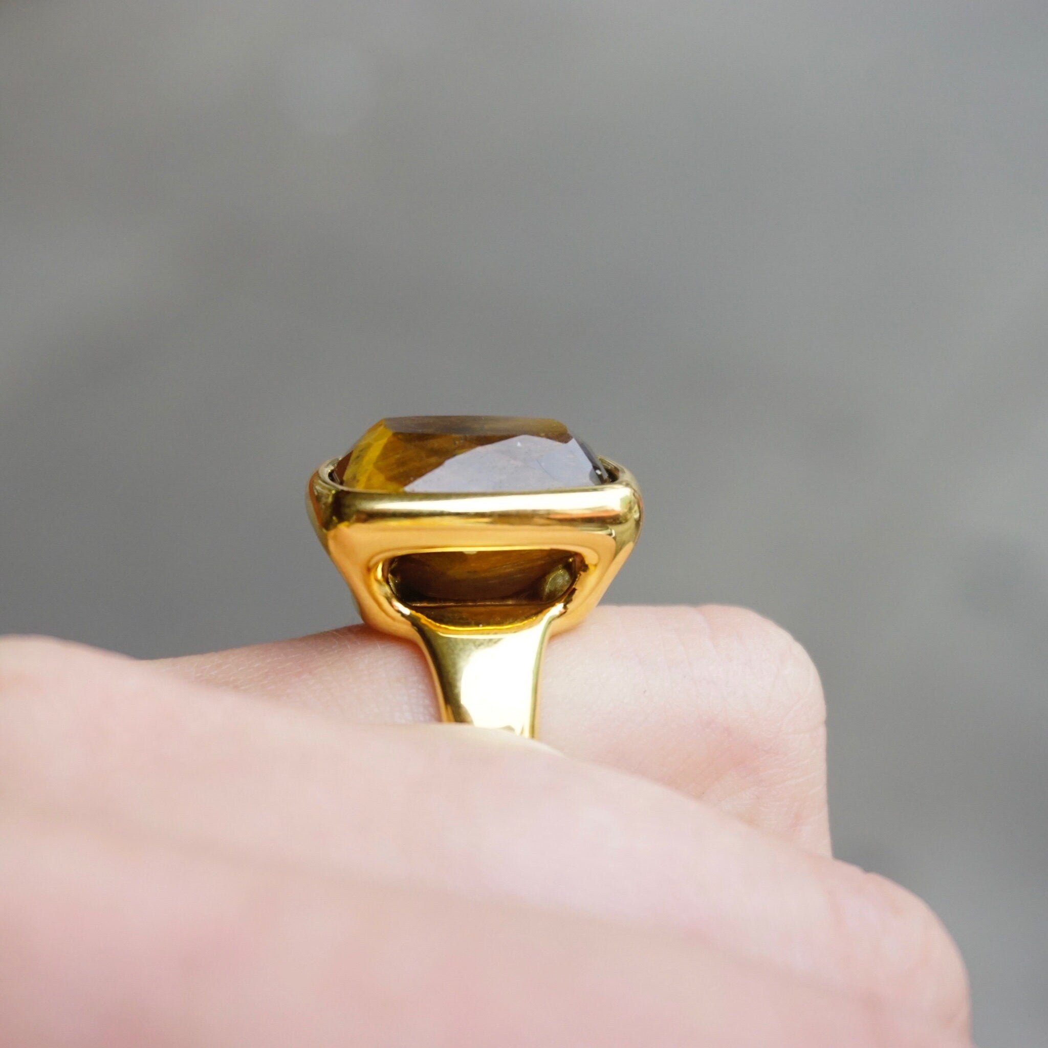 Vintage 14K gold tigers eye ring with a large, rectangle cut tigers eye stone set in a gold bezel setting, made by Milor in Italy using 14K gold over resin.