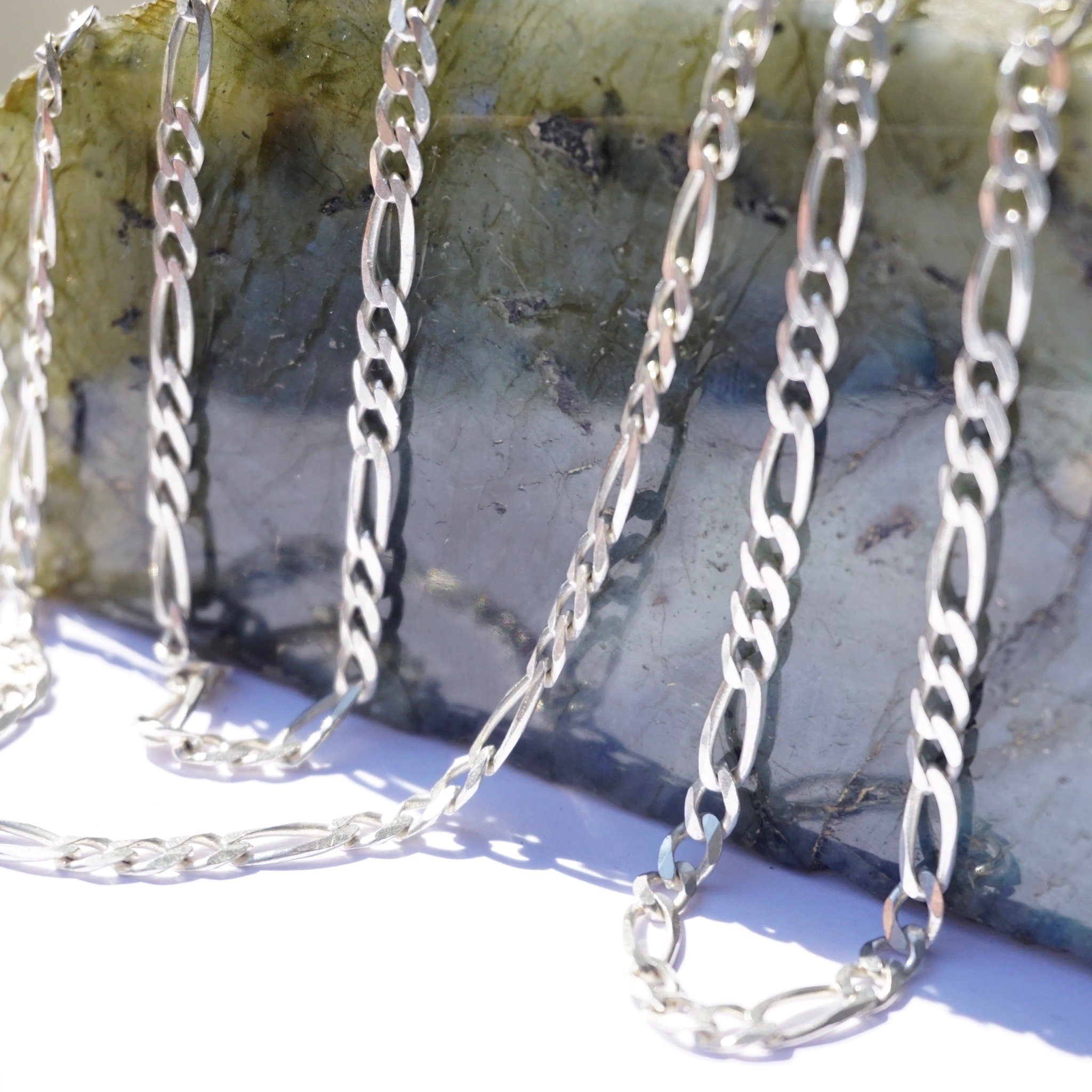 Vintage sterling silver figaro chain necklaces hanging over rocks, 34 inches long, made in Italy 925 silver, for layering or wearing long.