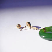 Vintage 14K gold dangle earrings with green jade hoops, featuring Chinese symbol design. Delicate stud earrings with dangling natural jade drops.