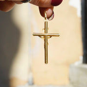 14K yellow gold INRI crucifix pendant, vintage Italian-made Orthodox cross necklace held in hand
