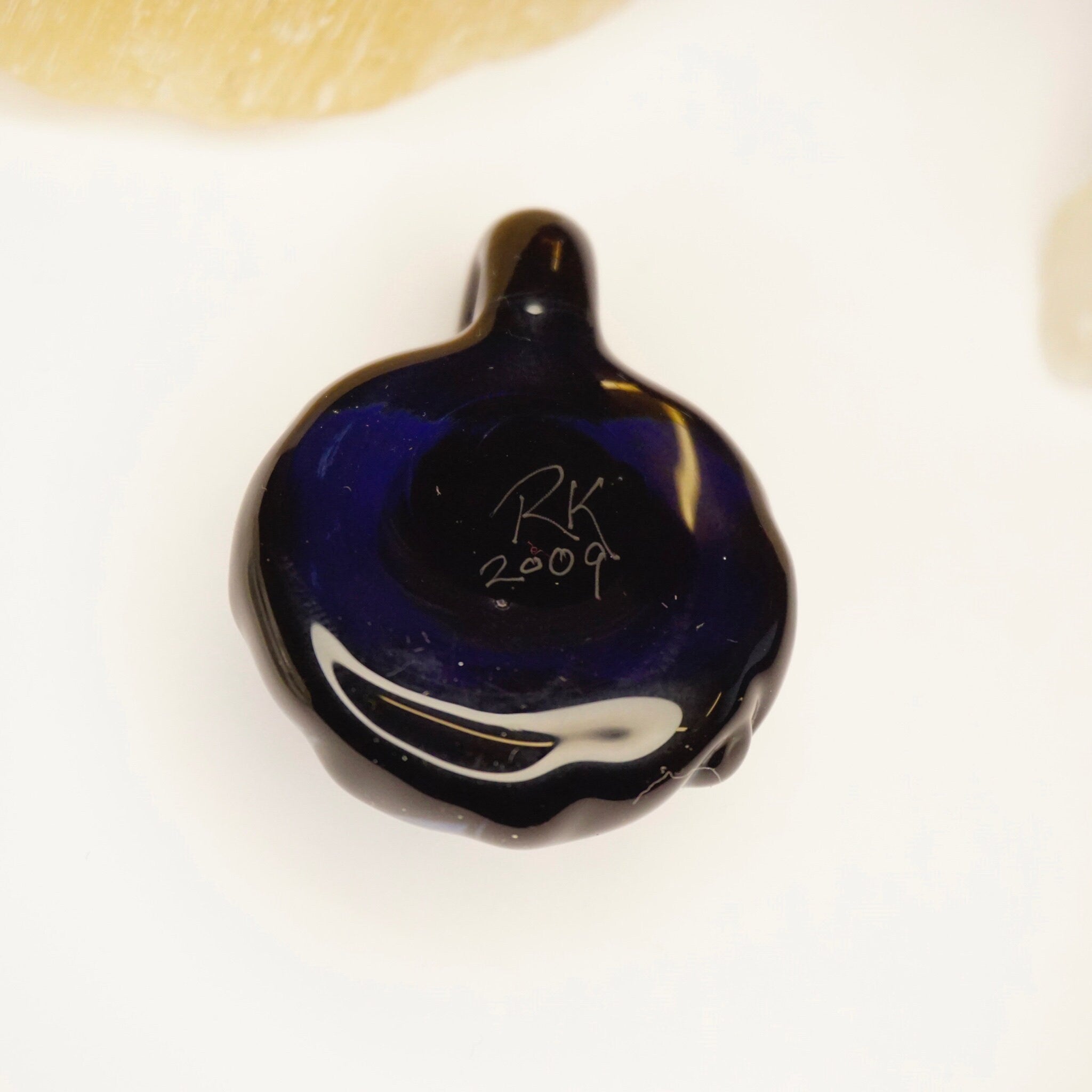 Blue and black retro glass pendant with abstract swirl design, modernist artisan jewelry