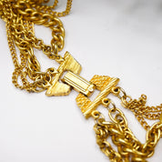 Vintage gold tone layered chain necklace with multiple strands and gold pendants