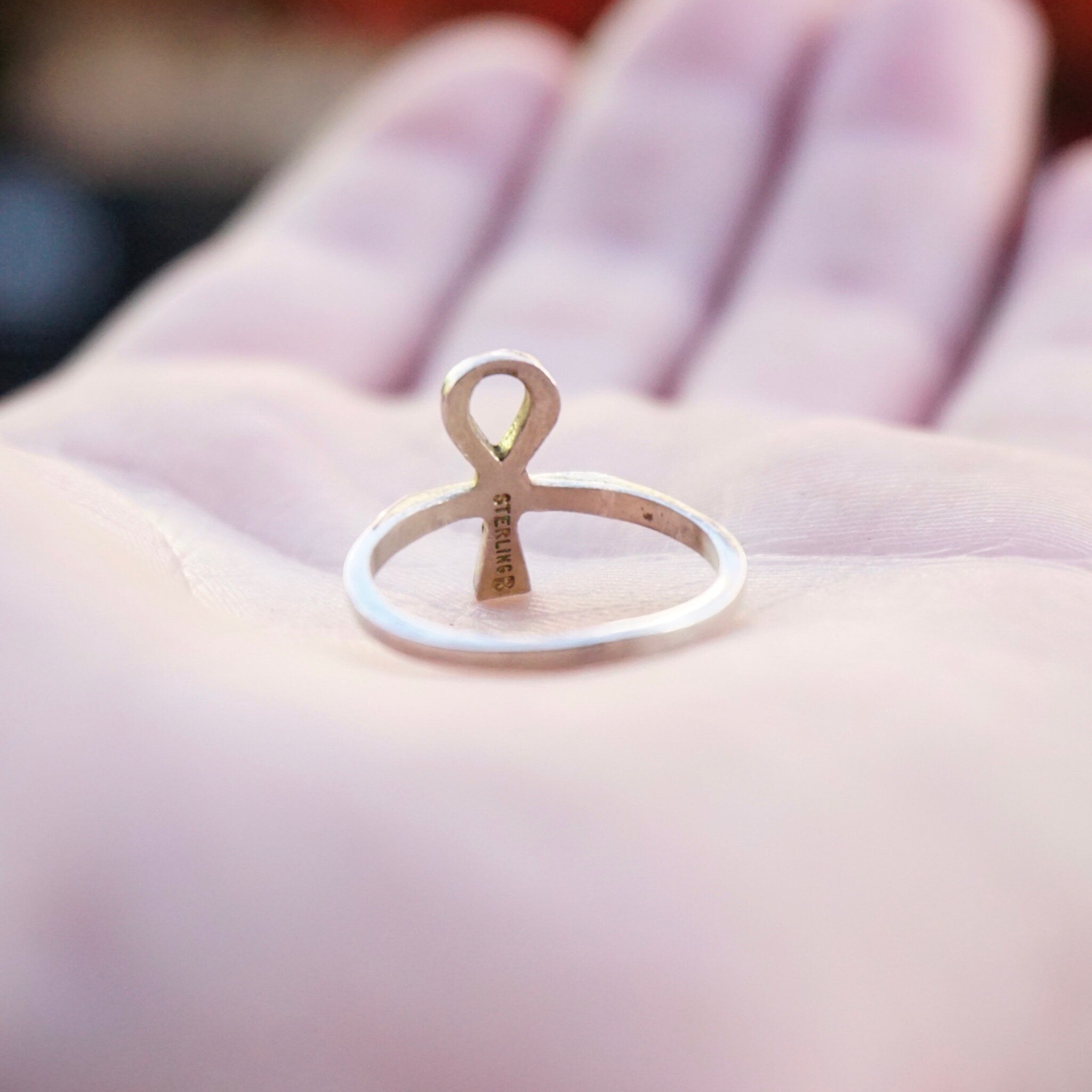 Vintage sterling silver Ankh ring on open palm, petite Egyptian hieroglyphic cross thin band, 925 silver jewelry closeup