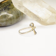 Vintage sterling silver Ankh ring on white background near crystals