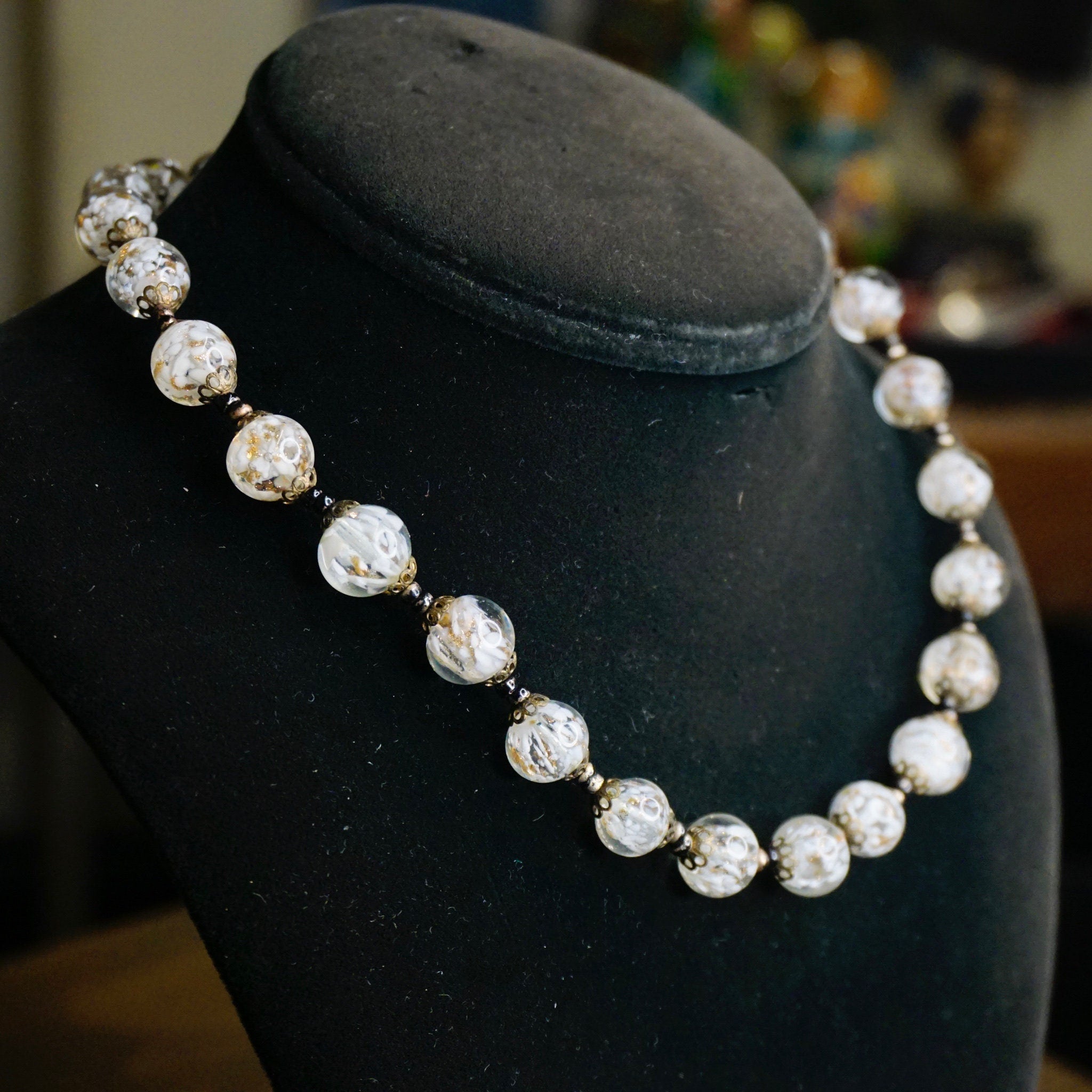Vintage Italian Murano glass wedding cake bead choker necklace displayed on black jewelry bust