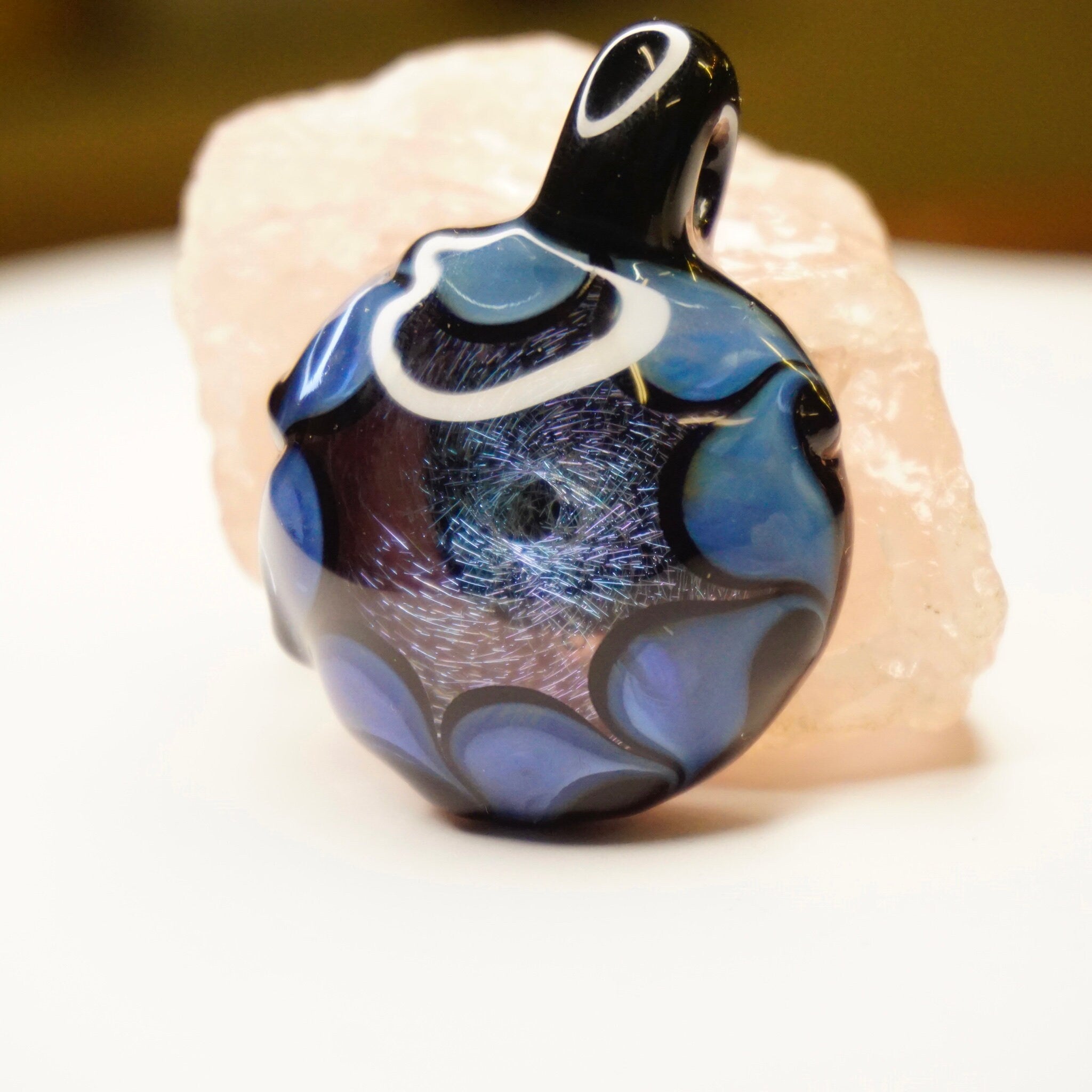 Retro glass pendant with abstract blue and black swirl design, handmade artisan jewelry featuring light fractals and modernist style.