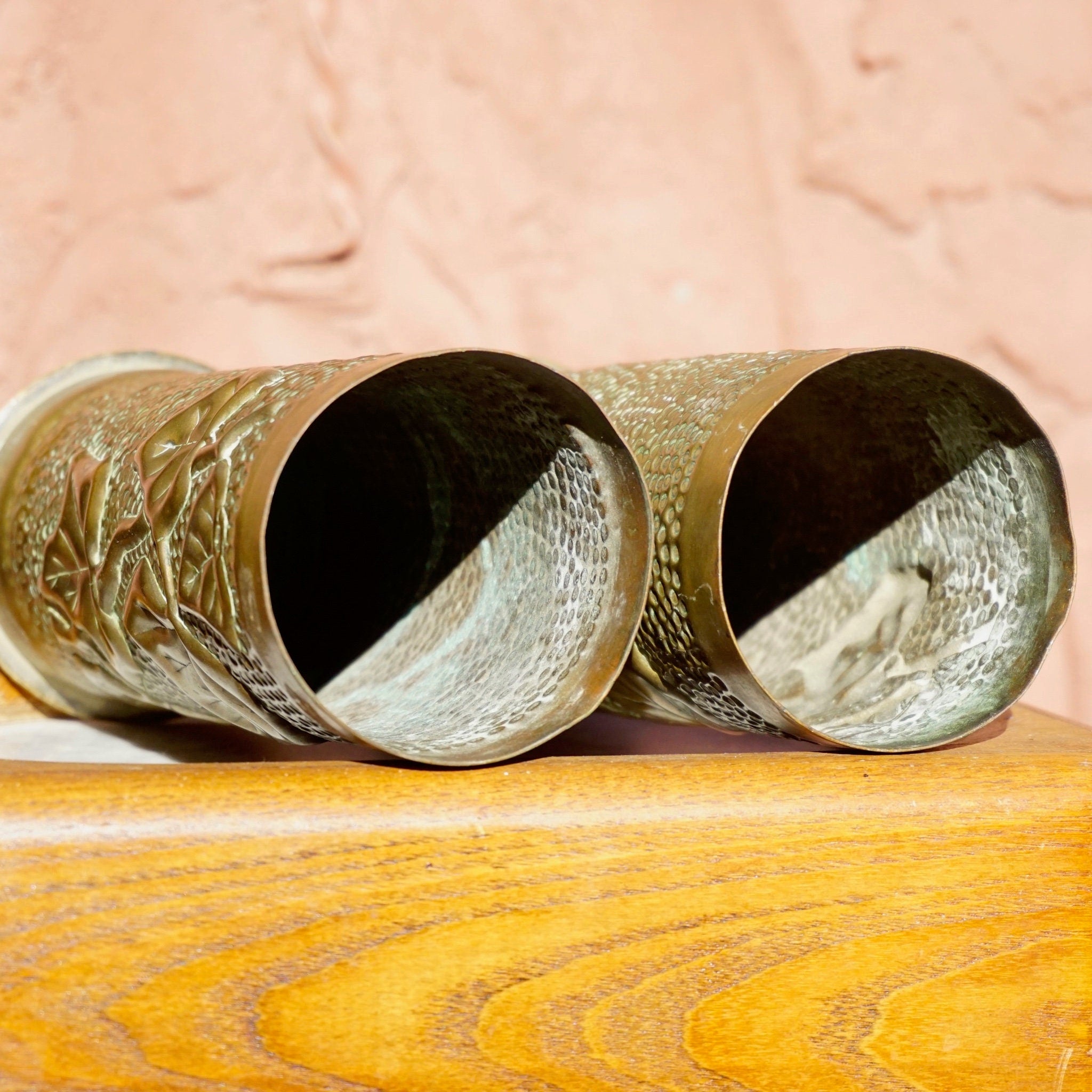 Antique French trench art brush holders made from etched brass shell casings with leaf design, dated 1917.