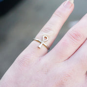 Vintage sterling silver ankh ring on finger, thin petite design with Egyptian hieroglyphic cross symbol, 925 silver jewelry.