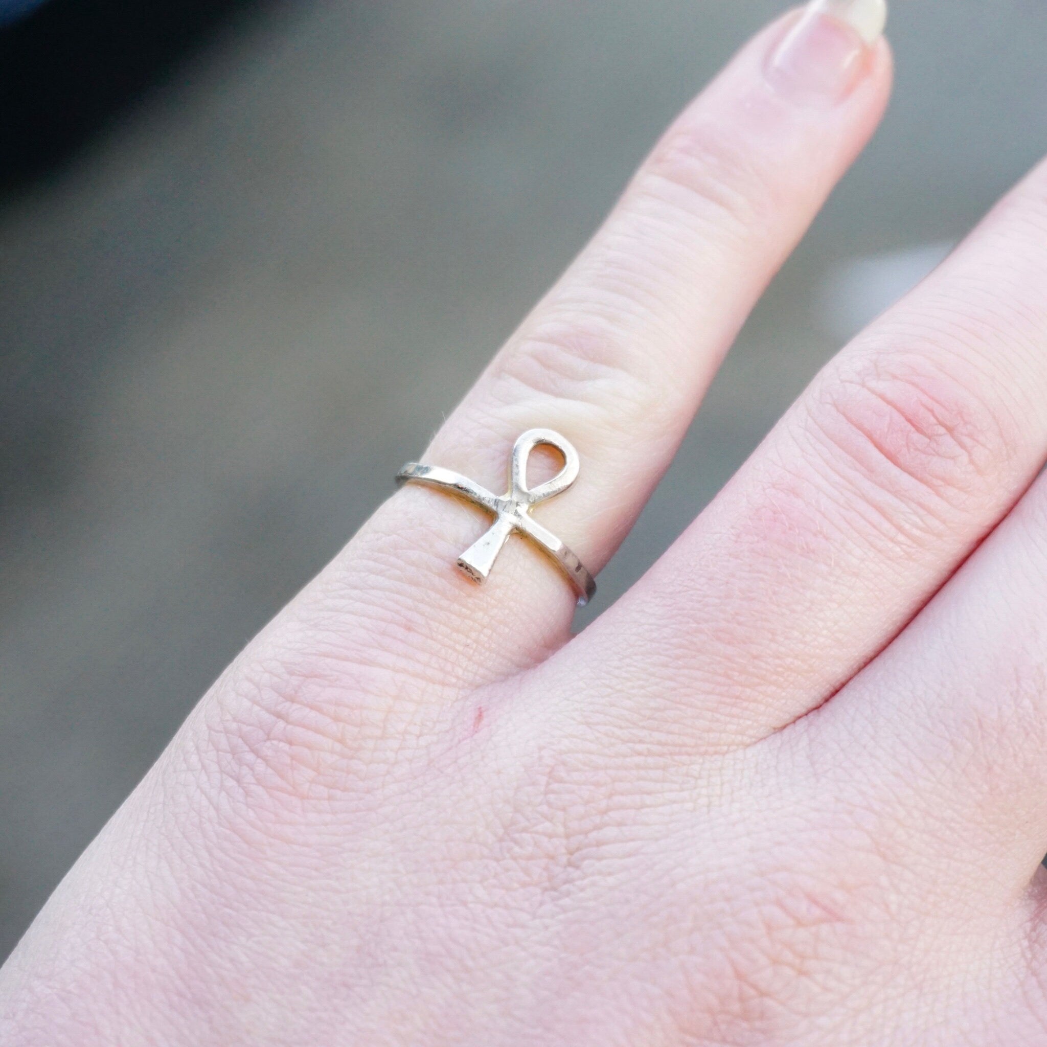 Vintage sterling silver ankh ring on finger, thin petite design with Egyptian hieroglyphic cross symbol, 925 silver jewelry.