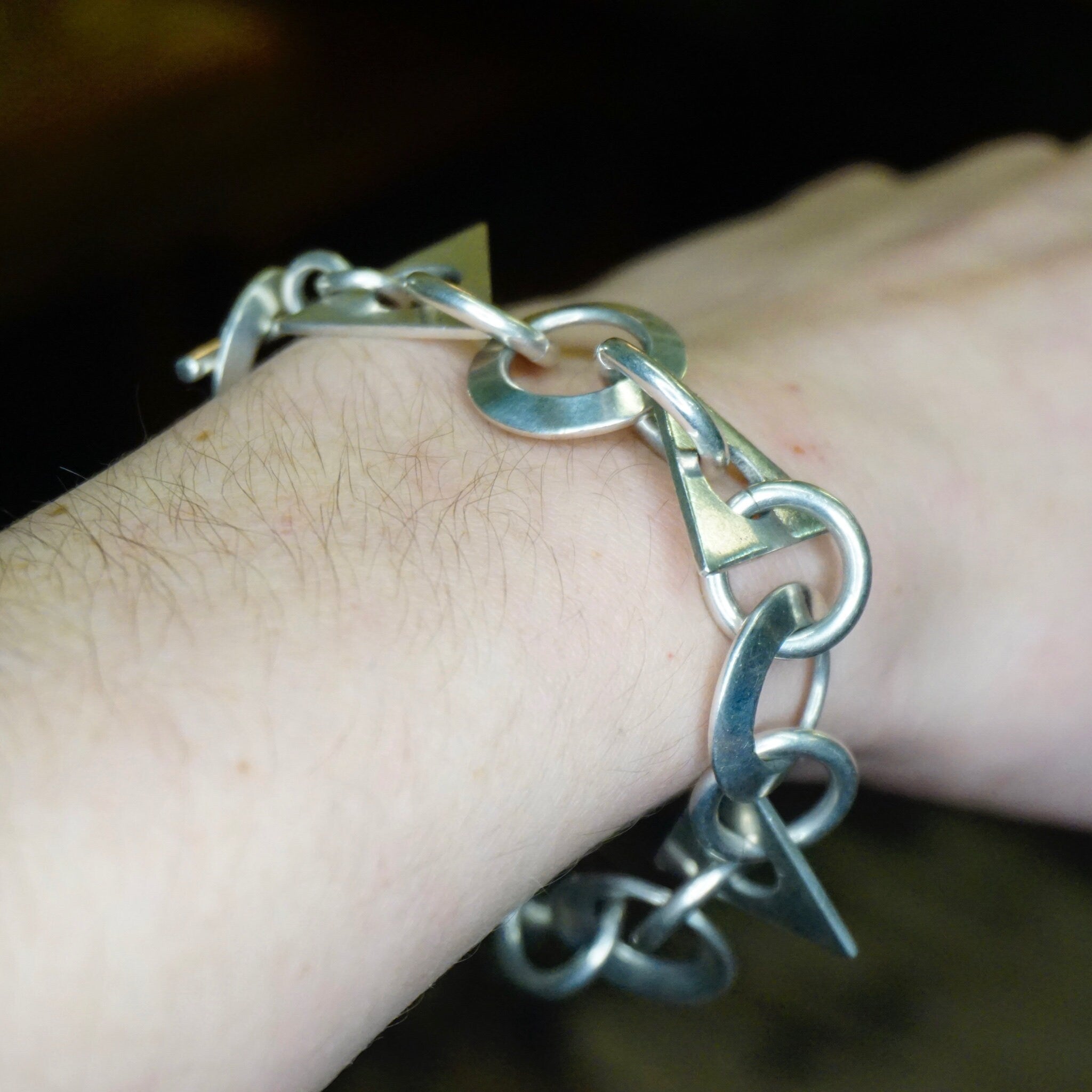 Vintage sterling silver link bracelet with geometric shapes and interlocking links, crafted in Taxco, Mexico. A modern 925 silver jewelry piece with an elegant, timeless design.