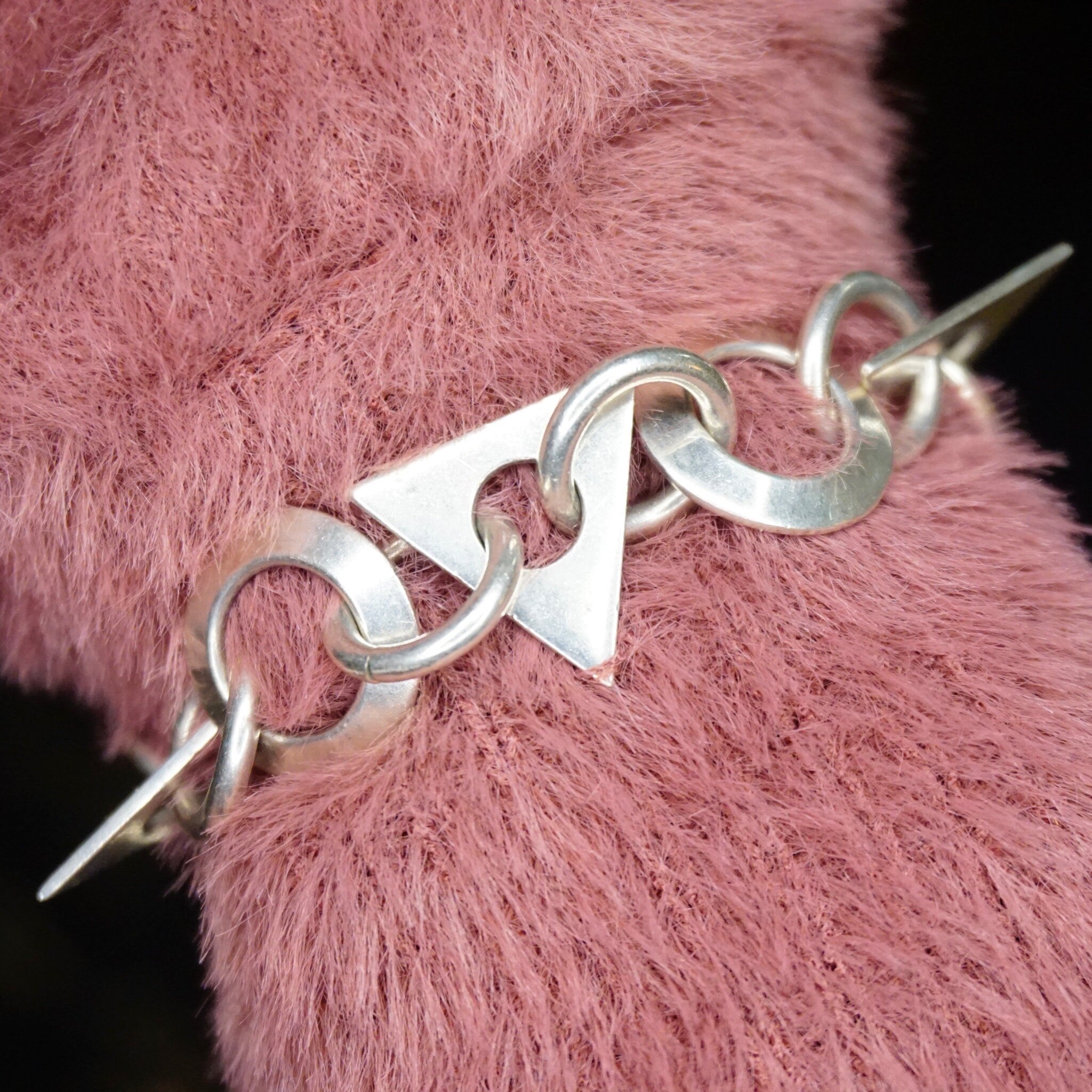 Vintage sterling silver link bracelet with geometric shapes on pink fur background, TAXCO 925 silver jewelry from Mexico