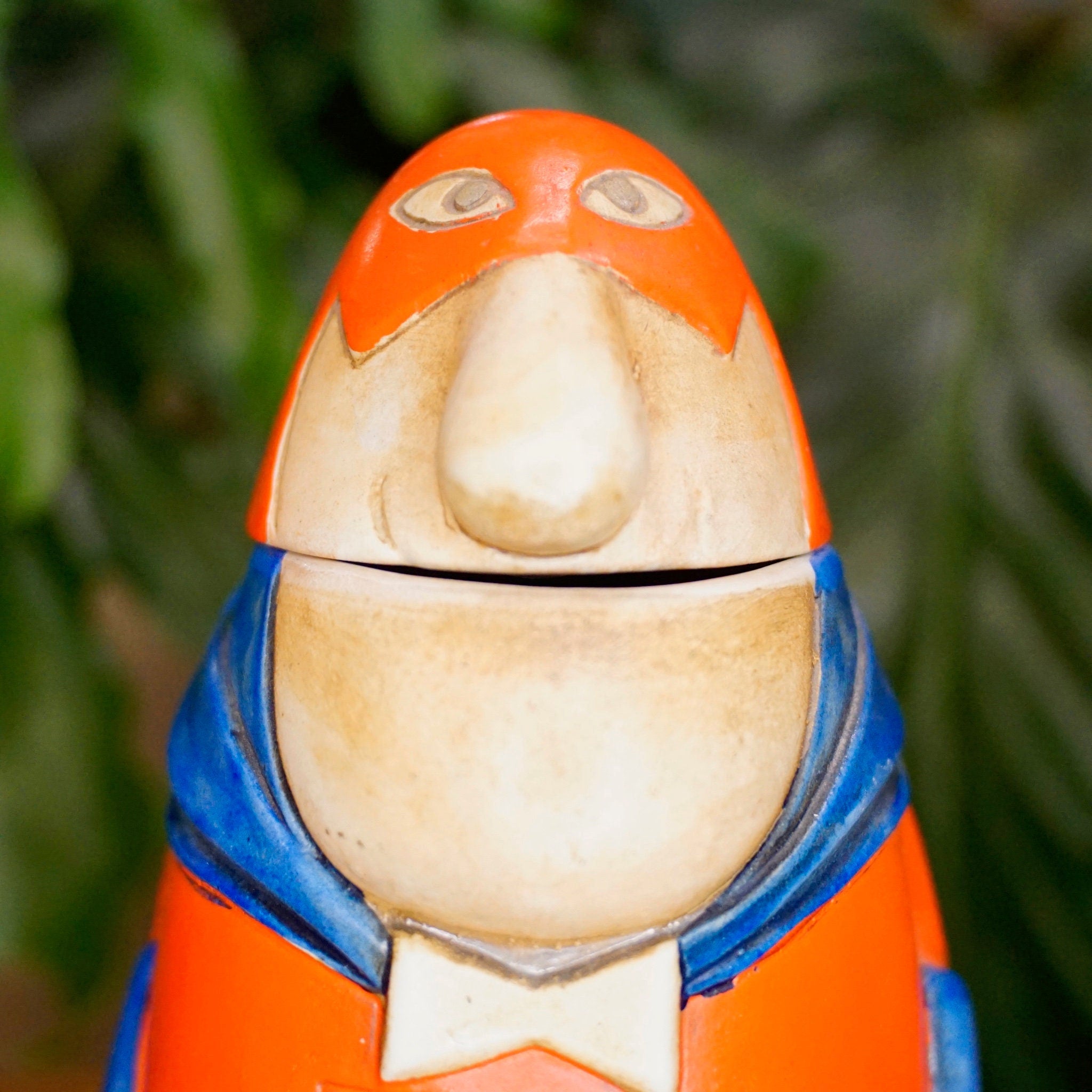 Orange and blue ceramic Bud Man beer stein figurine with bowtie and smiling expression, made by Ceramarte in Brazil in 1975, collectible Anheuser Busch debut Bud Man stein