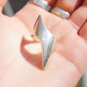 Vintage sterling silver lightning bolt ring on a hand, featuring an elongated pointed design. Solid 925 silver ring from Israel in a petite, long style. Size 5 1/2 US.