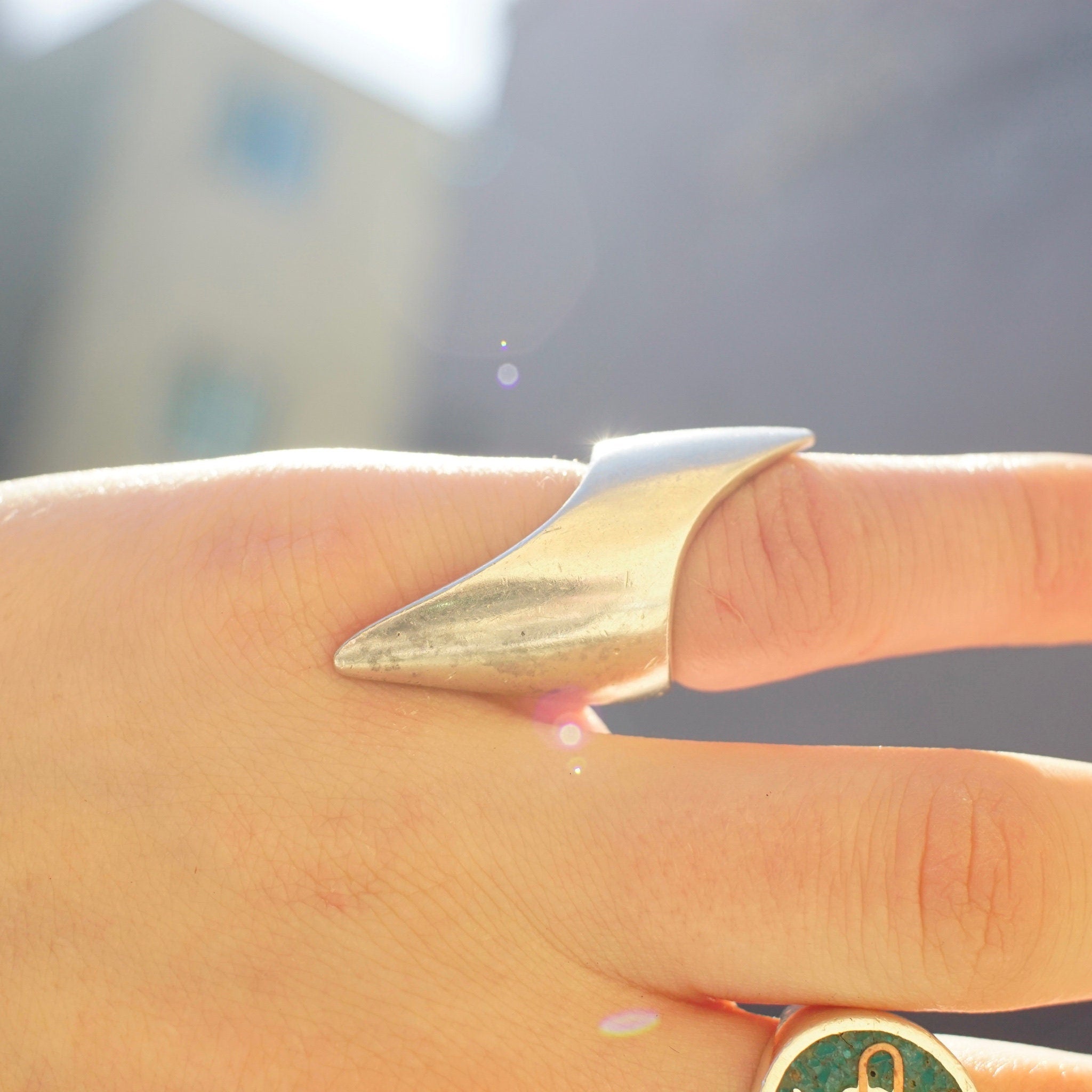 Vintage sterling silver lightning bolt ring on a person's finger, featuring elongated points and a petite design, made in Israel with 925 silver, size 5 1/2 US.