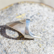 Vintage sterling silver lightning bolt ring on gravel surface