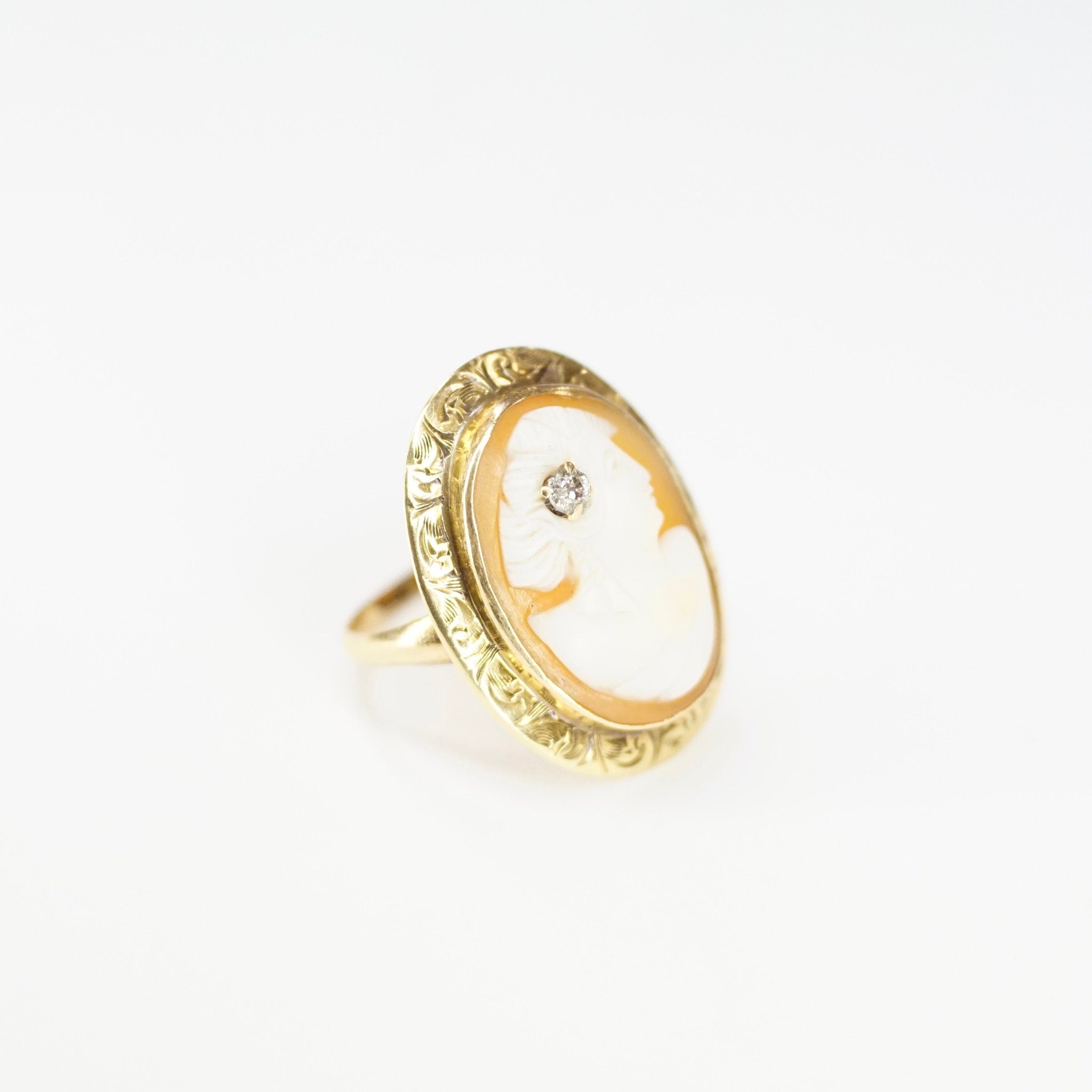 Vintage 14K gold carved shell cameo ring with ornate setting and accent diamond, antique ring in a size 3 3/4 US.