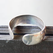 Vintage sterling silver cuff bracelet with etched floral design, made by S. Kirk & Son. The cuff has a polished silver finish and space for an engraved monogram.