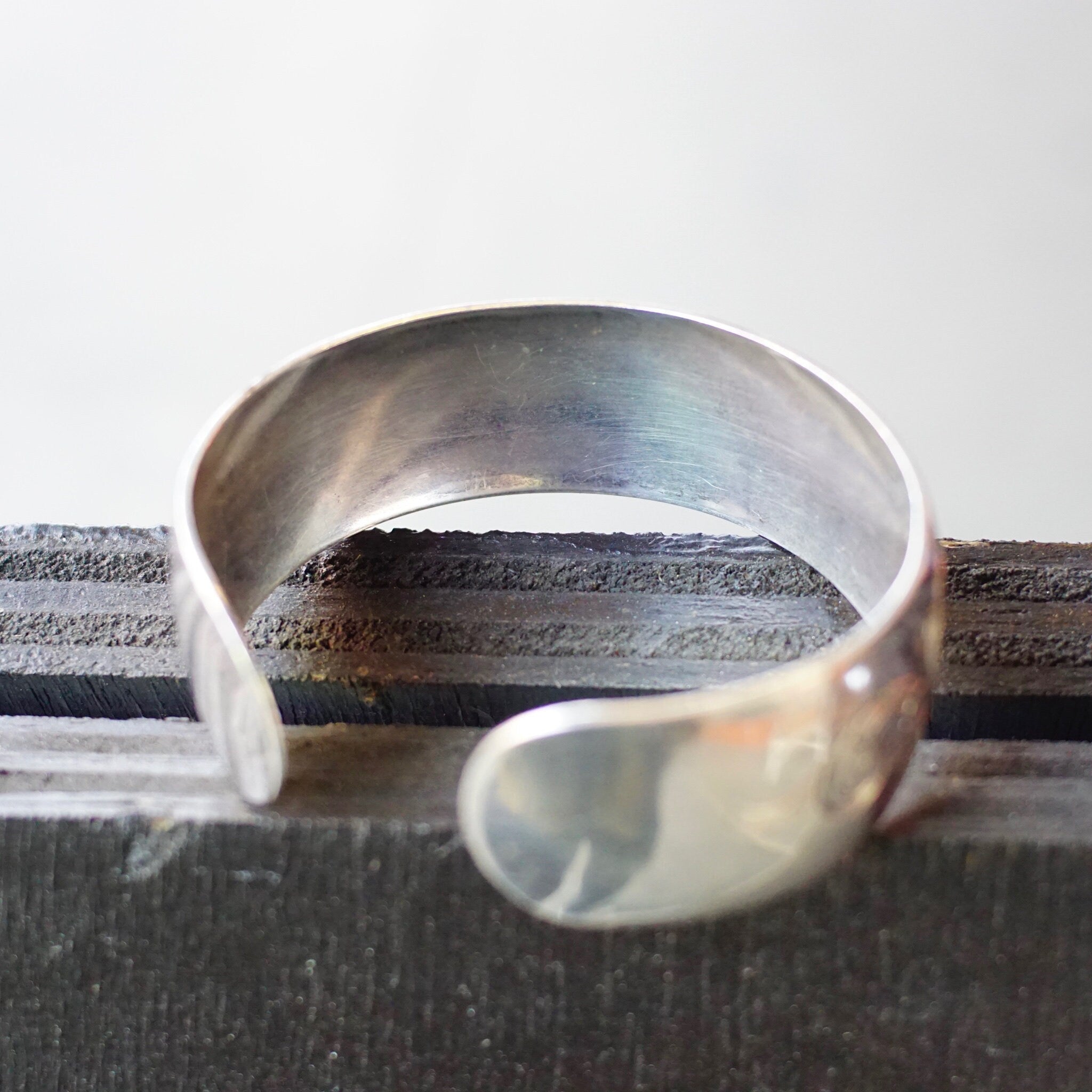 Vintage sterling silver cuff bracelet with etched floral design, made by S. Kirk & Son. The cuff has a polished silver finish and space for an engraved monogram.
