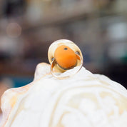 Vintage 14K gold ring featuring a carved shell cameo and an accent diamond, set in an ornate gold mounting. Antique cameo ring in a size 3 3/4 US.