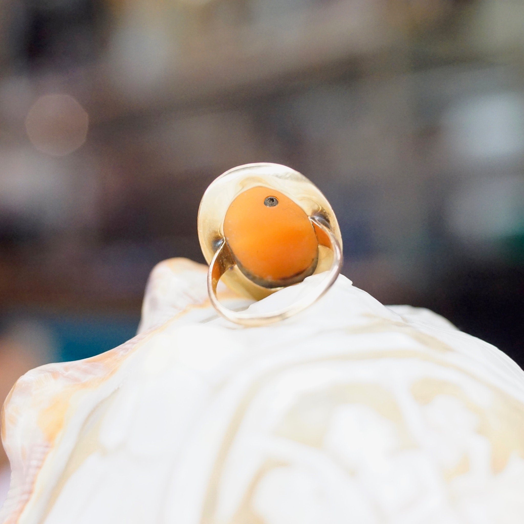 Vintage 14K gold ring featuring a carved shell cameo and an accent diamond, set in an ornate gold mounting. Antique cameo ring in a size 3 3/4 US.