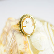 Vintage 14K gold carved shell cameo ring with diamond accent in ornate setting, antique style, size 3 3/4 US.