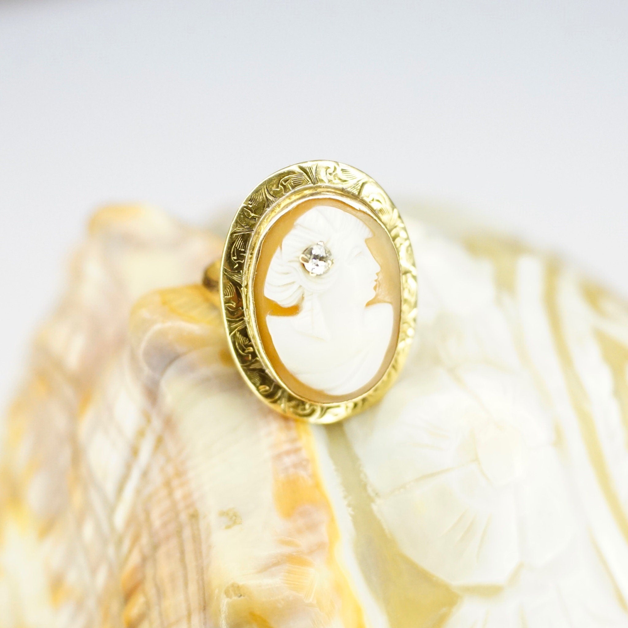 Vintage 14K gold carved shell cameo ring with diamond accent in ornate setting, antique style, size 3 3/4 US.