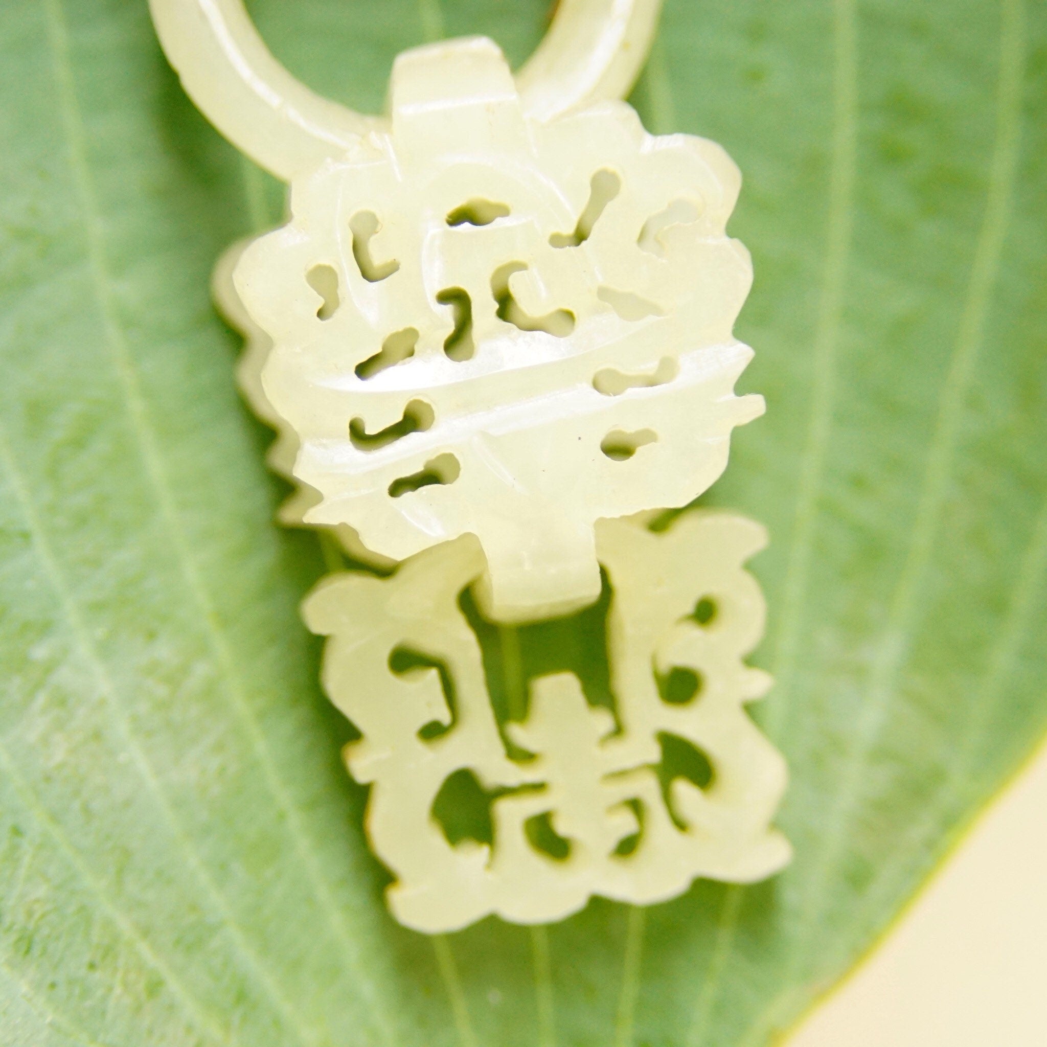 Intricate hand-carved nephrite jade butterfly brooch with gold wash silver filigree and enamel detailing, resembling a delicate wedding basket design from antique Chinese silversmithing.