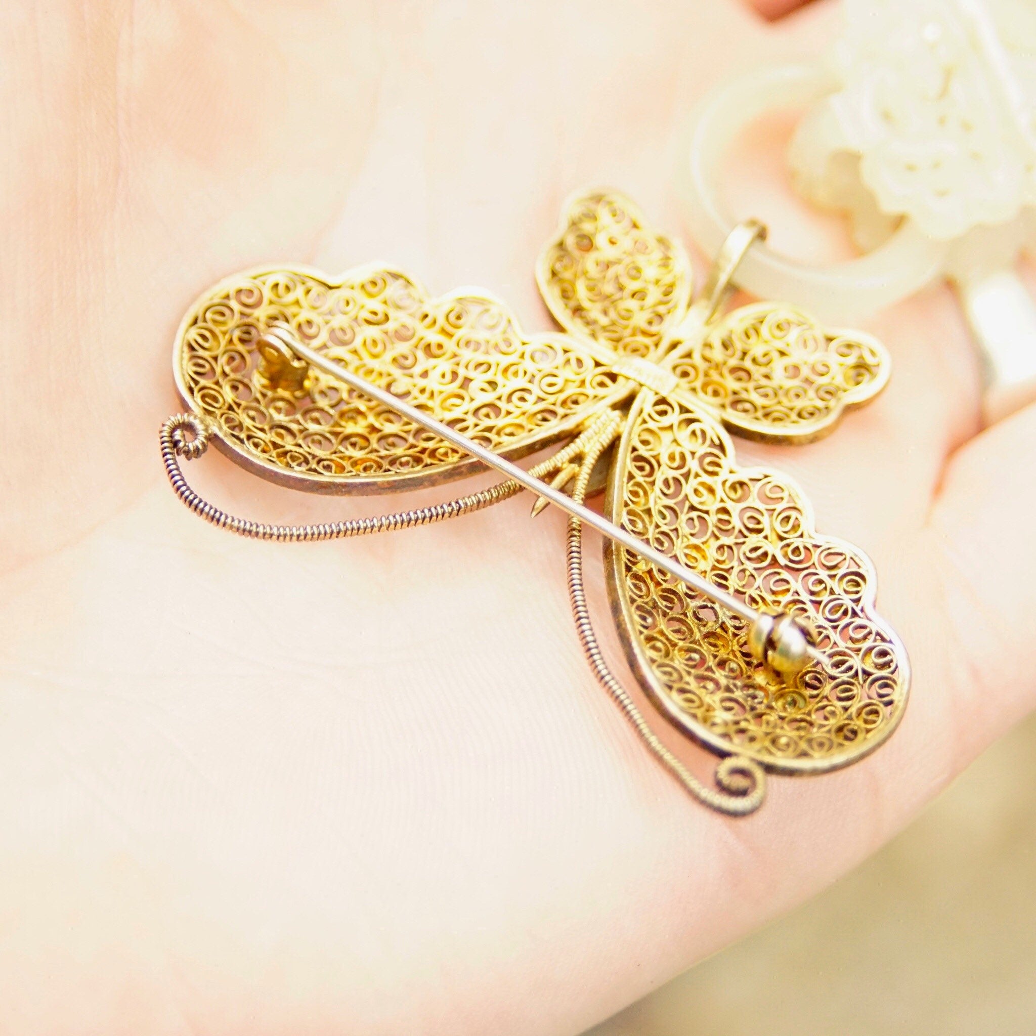 Antique Chinese gold washed silver filigree butterfly brooch with intricately carved nephrite jade, featuring a hand-carved jade wedding basket design, crafted using traditional 'Devil's Work' metalworking techniques.