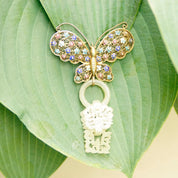 Antique Chinese silver filigree butterfly brooch with devil's work design, gold wash silver and enamel accents, featuring a hand-carved nephrite jade wedding basket charm.