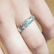 Vintage sterling silver turquoise inlay ring on a finger, featuring a light blue speckled turquoise stone set in a tapered silver band, size 8 1/2 US.