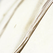 Vintage modernist sterling silver multi-strand liquid silver necklace with coned caps and hook closure, 30 inches long, 925 silver statement necklace closeup on white fabric