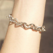 18K gold and sterling silver heart link bracelet from Tiffany & Co, featuring two-tone curb links. Vintage Tiffany jewelry, measuring 7 1/2 inches long.