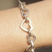 Vintage Tiffany & Co 18K gold and sterling silver heart link bracelet with alternating two-tone curb links, measuring 7 1/2 inches long.