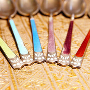 Colorful antique sterling silver demitasse spoons with art deco guilloche enamel handles in red, turquoise and light blue, set of 6 Scandinavian decorative tea spoons marked 930S, on ornate woven gold fabric background.