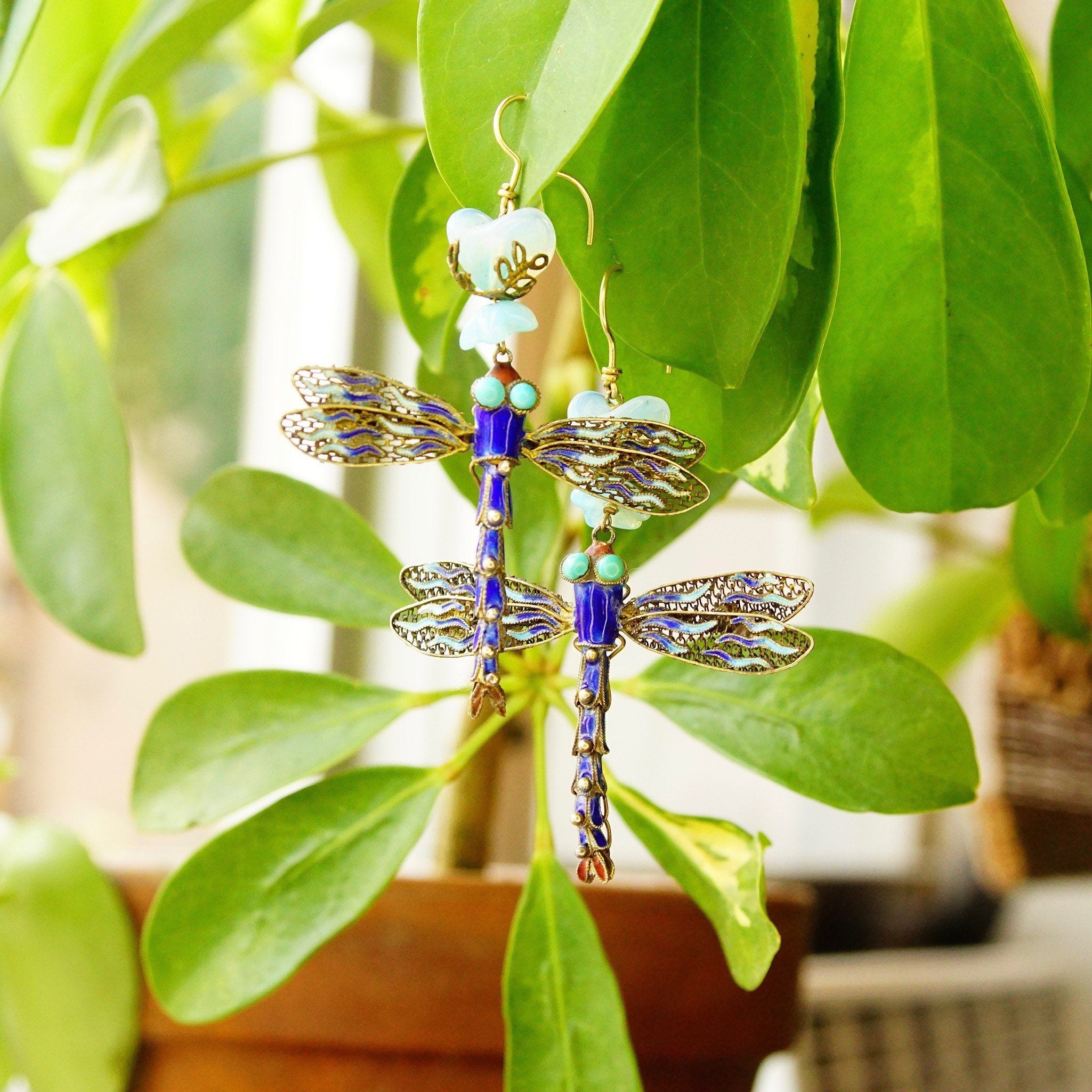 Vintage Chinese gilt sterling silver filigree articulated blue enamel dragonfly dangle earrings with opalescent blue glass stones, measuring 3 inches long.