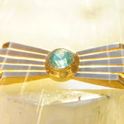 Vintage 14K rose gold Art Deco bar pin brooch featuring a brilliant blue aquamarine gemstone in a radiant golden ray setting, measuring 2 inches long, stamped 585.