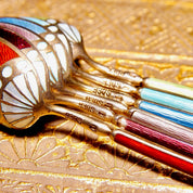 Colorful antique Art Deco sterling silver guilloche enamel demitasse spoon set with Scandinavian 930S markings on ornate gold textured background