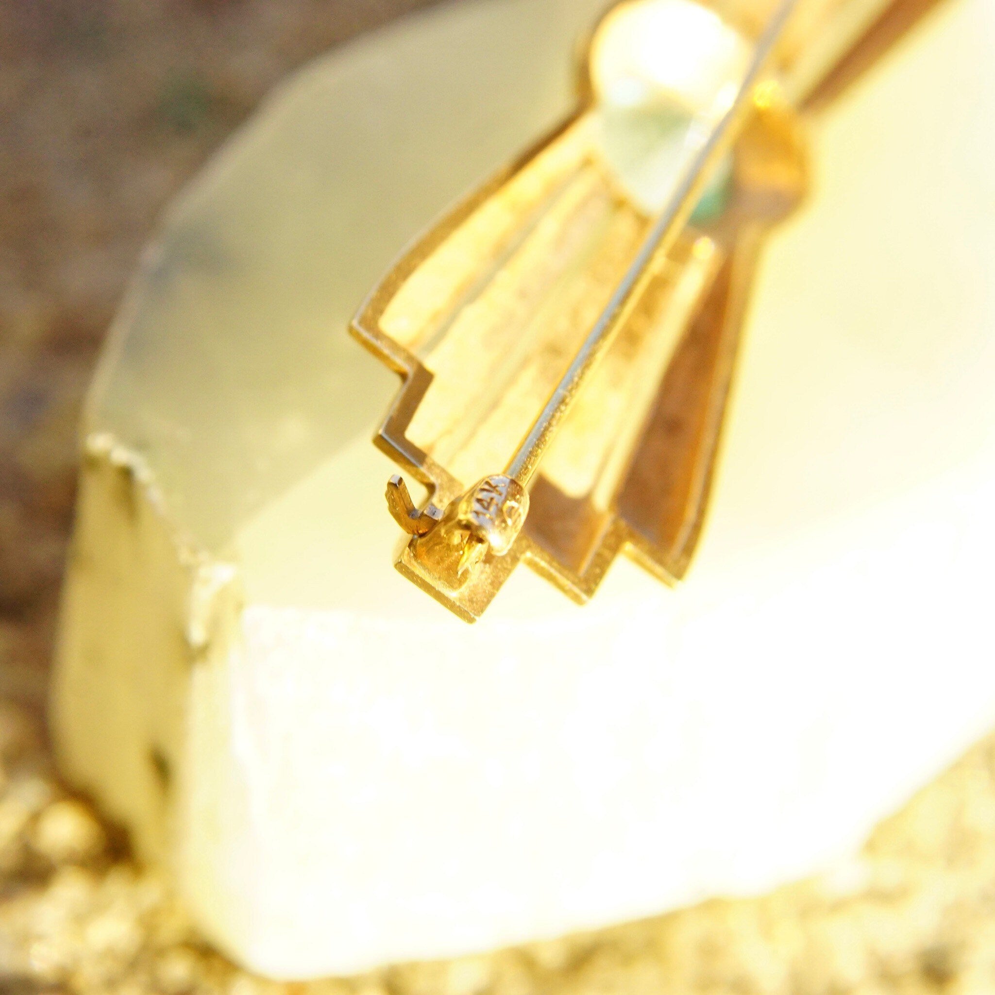 Vintage 14K rose gold art deco bar pin brooch with brilliant blue aquamarine gemstone in golden ray deco setting, measuring 2 inches long.
