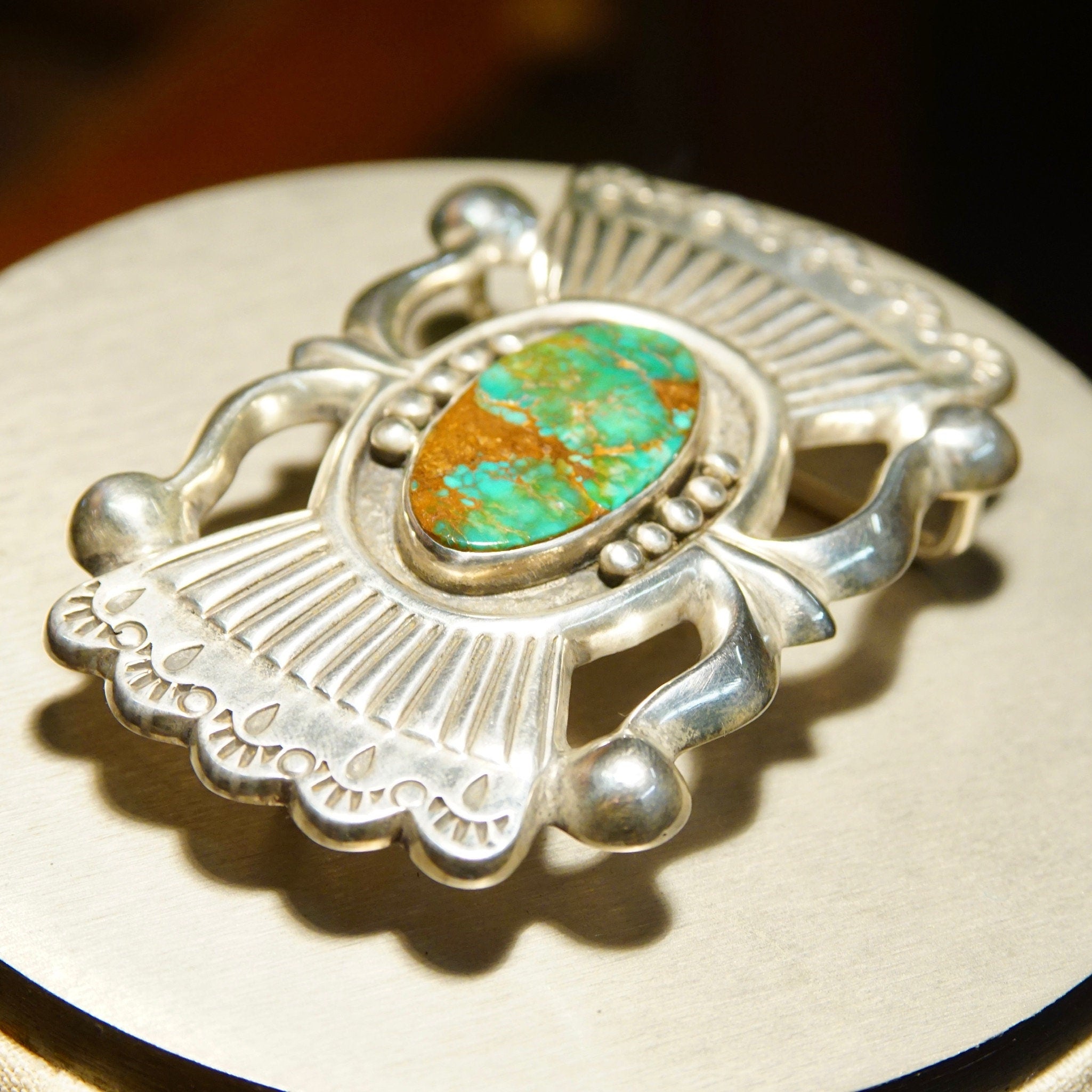 Vintage Native American sterling silver turquoise belt buckle featuring intricate sandcast design by renowned Zuni artisan Art Acoya, measuring 2 7/8 inches wide, showcasing vibrant blue-green turquoise stone at center.