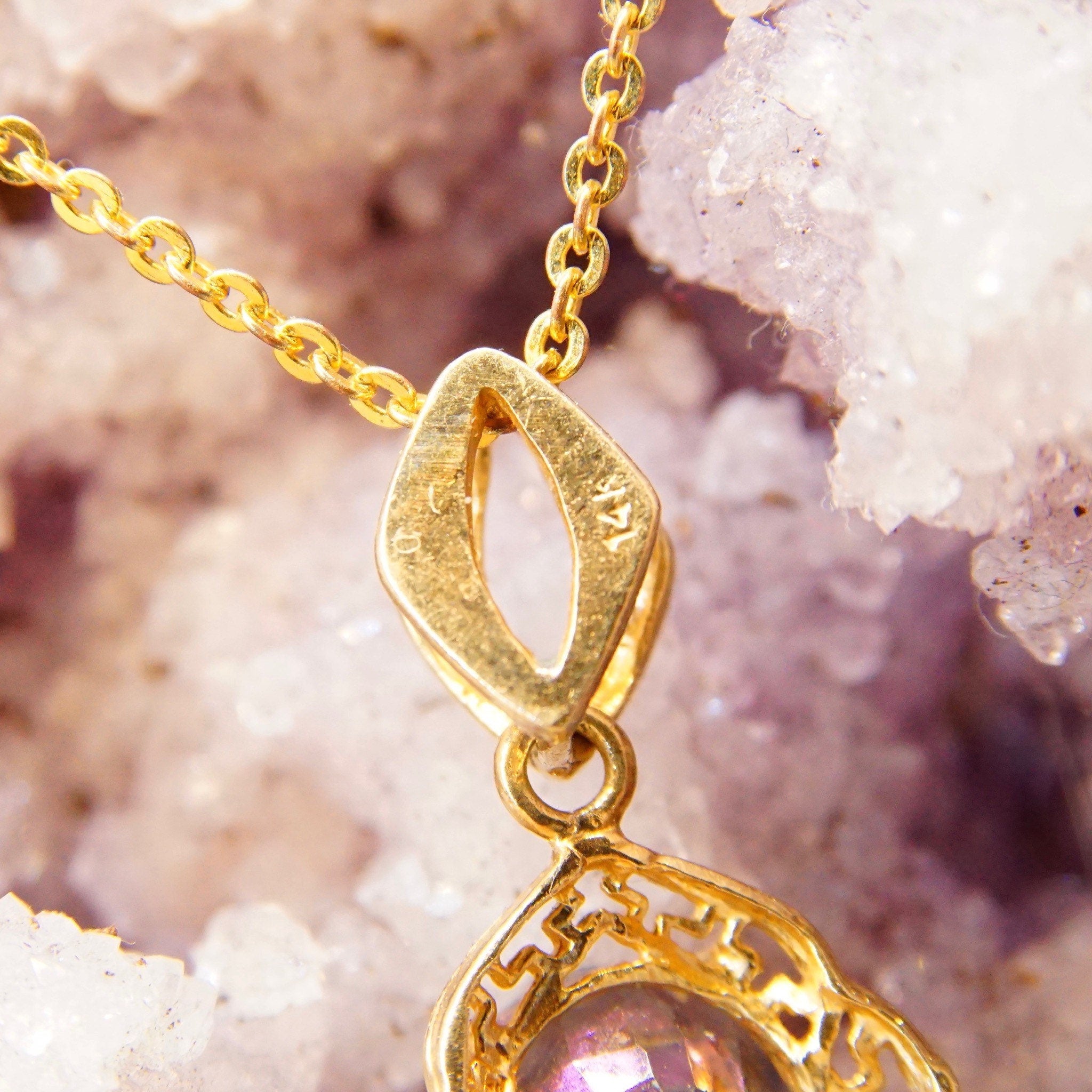 Vintage 14K yellow gold mystic fire topaz pendant necklace featuring an ornate setting and bail with a 26mm x 13mm faceted purple and green color-changing gemstone.